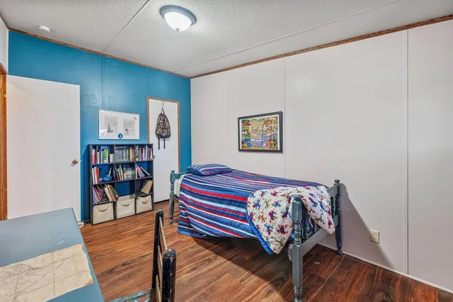 a room with a bed and a book shelf