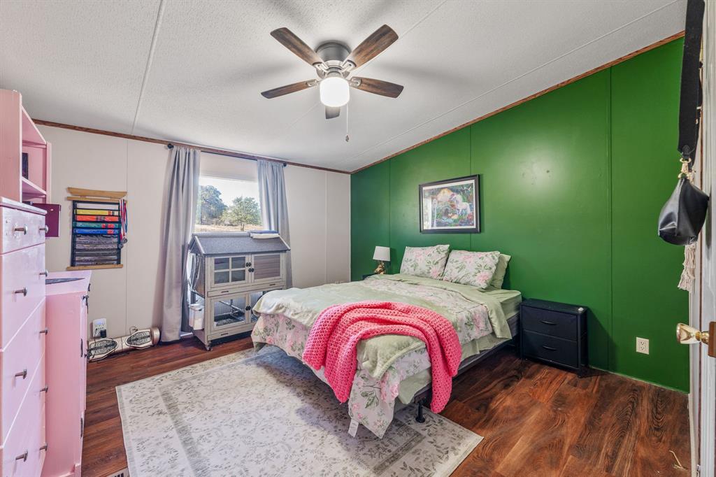 192 Big Salty Lane Springtown, TX 76082 - Photo 19 of 36 a bed room with a bed and a window