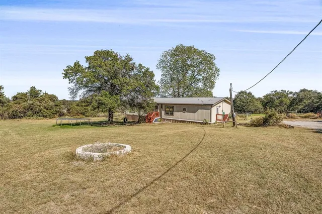 a view of a house with yard and sitting area