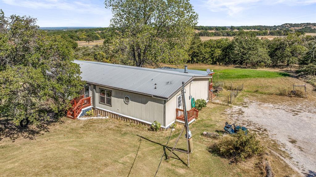 192 Big Salty Lane Springtown, TX 76082 - Photo 32 of 36 an aerial view of a house with a yard and mountain view in back