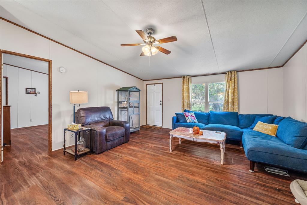 192 Big Salty Lane Springtown, TX 76082 - Photo 8 of 36 a living room with furniture and a wooden floor