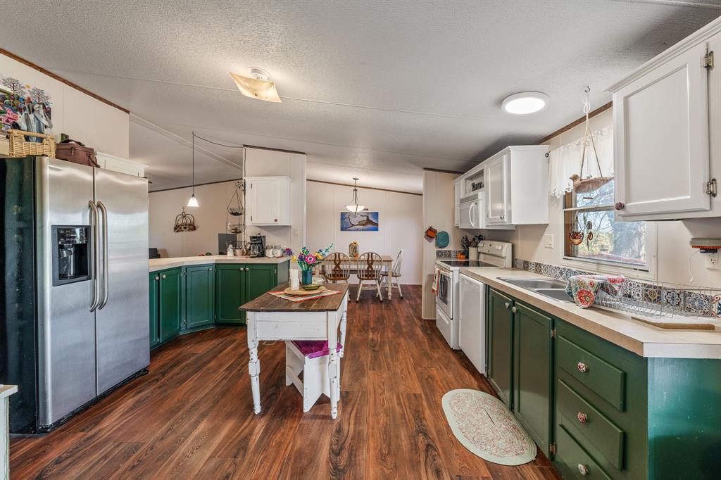 192 Big Salty Lane Springtown, TX 76082 - Photo 10 of 36 a kitchen with a sink appliances cabinets and wooden floor