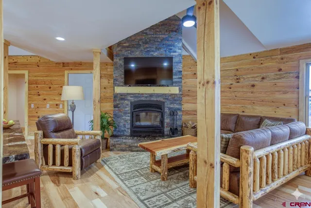 a living room with furniture and a fireplace