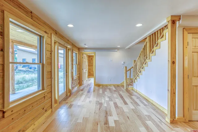 a view of an entryway with wooden floor and door