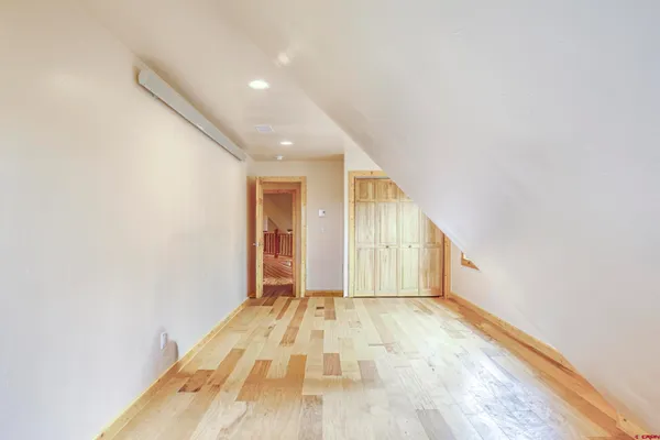 a view of an empty room window and wooden floor