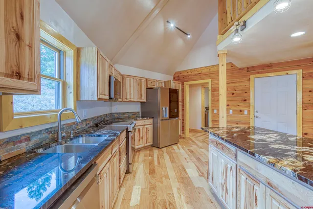 a spacious bathroom with a granite countertop sink and a large mirror