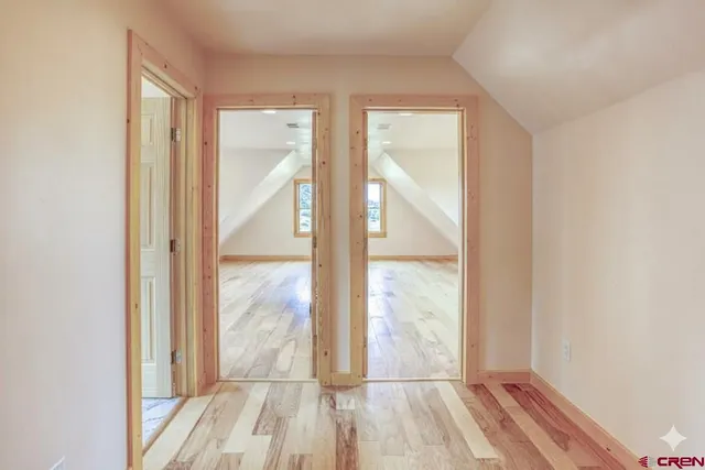 a view of hallway with wooden floor