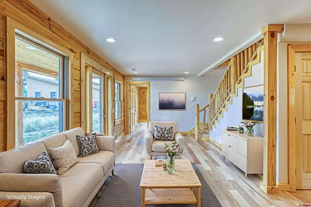a living room with furniture and a large window