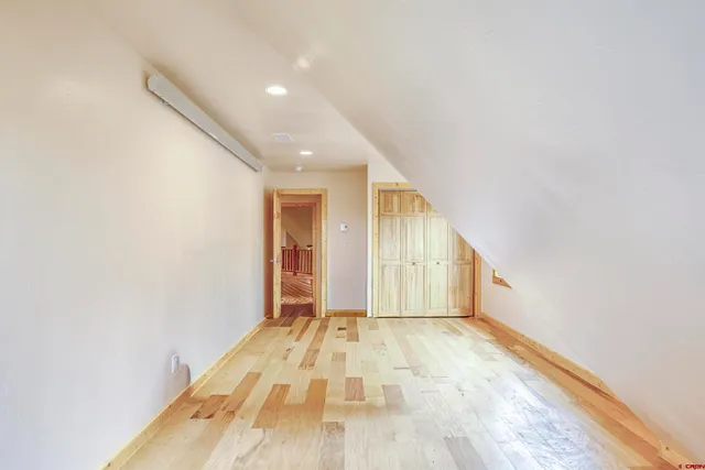 a view of an empty room window and wooden floor