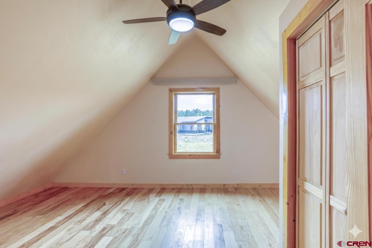 159 Snow Circle Pagosa Springs, CO 81147 - Photo 33 of 45 an empty room with a window and wooden floor