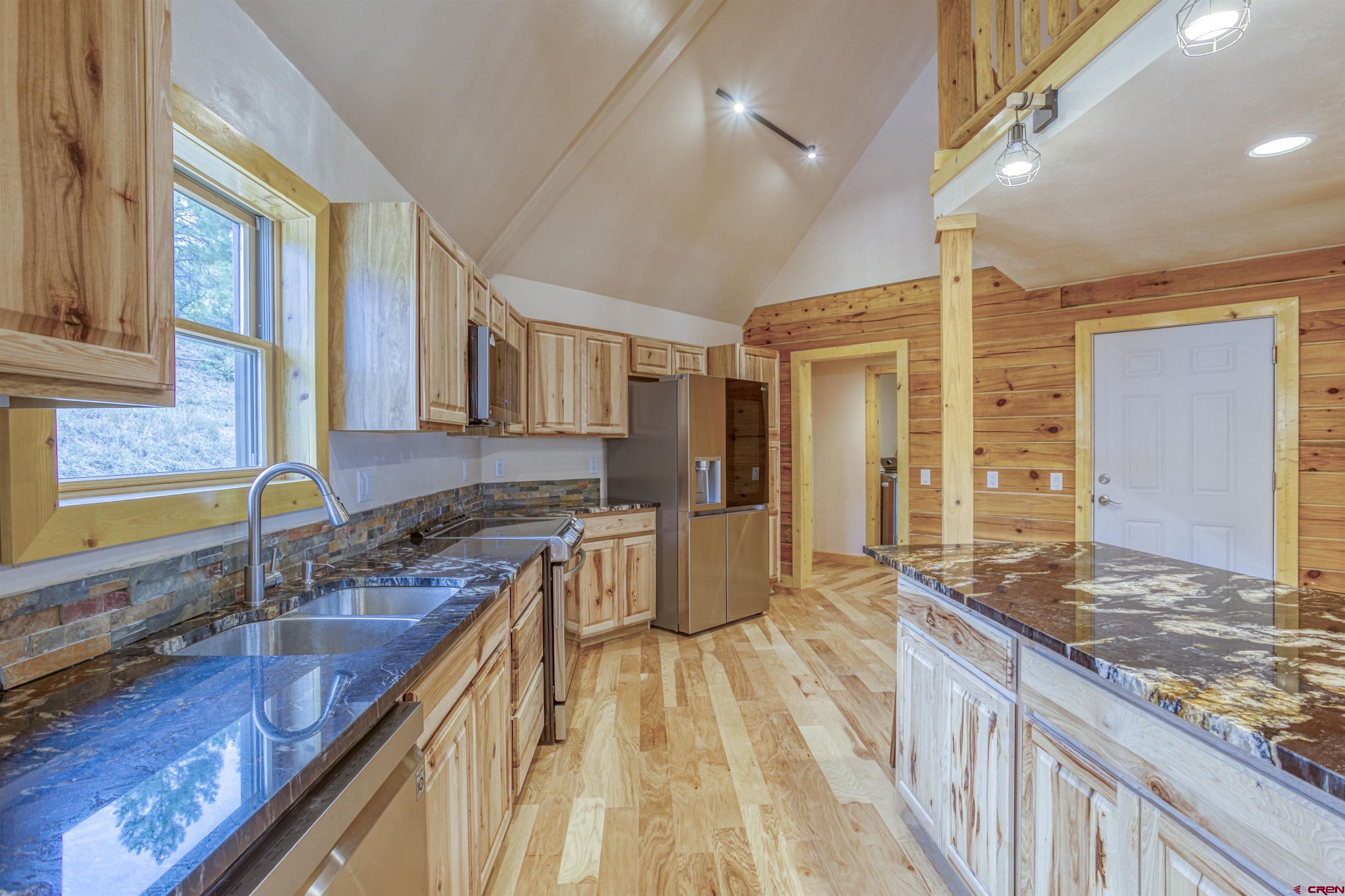 159 Snow Circle Pagosa Springs, CO 81147 - Photo 5 of 45 a spacious bathroom with a granite countertop sink and a large mirror