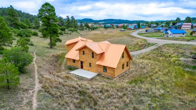 an aerial view of a house with lake view and boat