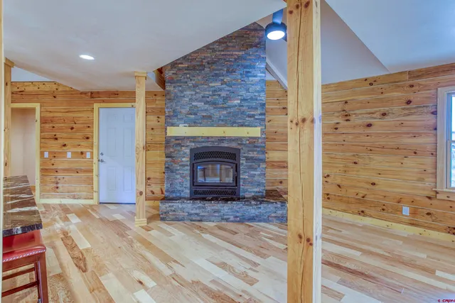 a view of livingroom with fireplace and wooden floor
