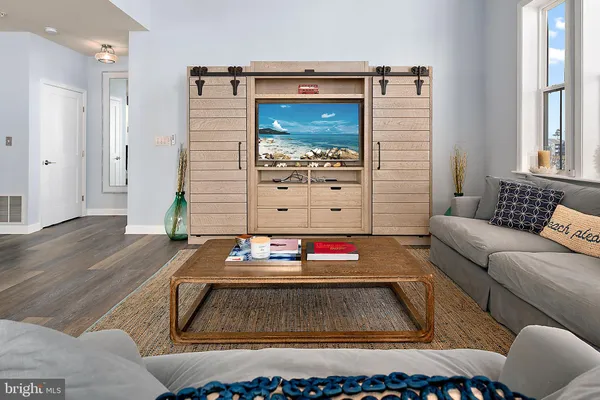 a living room with furniture and wooden floor