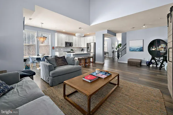 a kitchen with stainless steel appliances granite countertop a table chairs microwave and sink