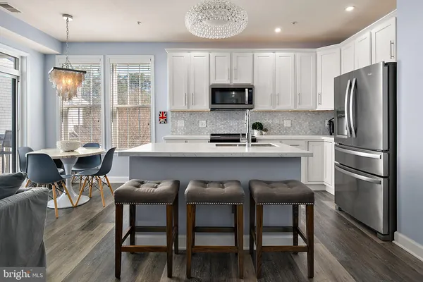 a kitchen with white cabinets stainless steel appliances and sink