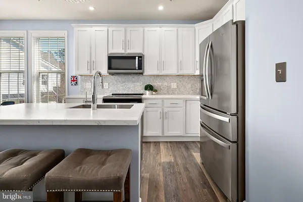 a kitchen with a sink and stainless steel appliances