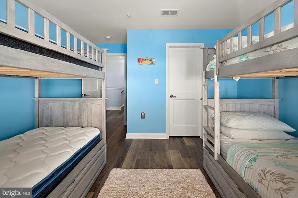 a bathroom with a granite countertop toilet and a sink