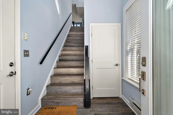 a view of entryway and hall with wooden floor