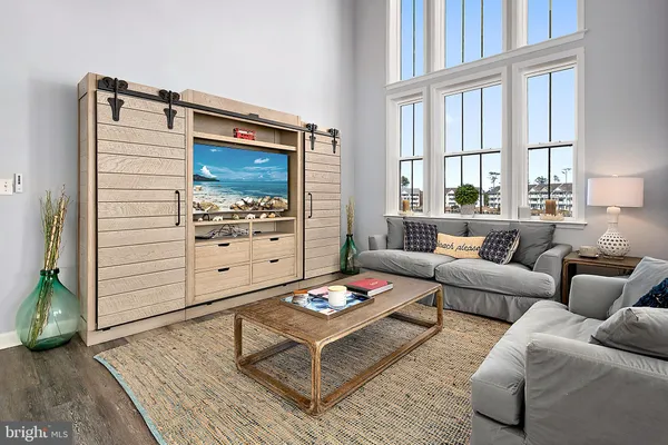 a living room with furniture fireplace and a large window