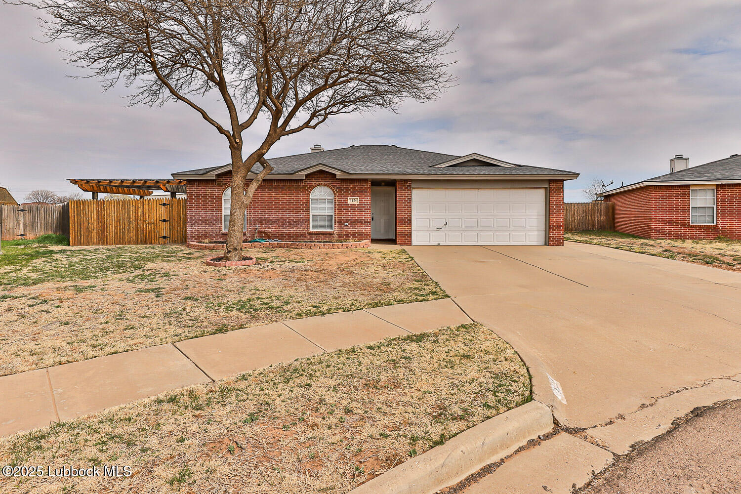 a large house with a large tree in front of it