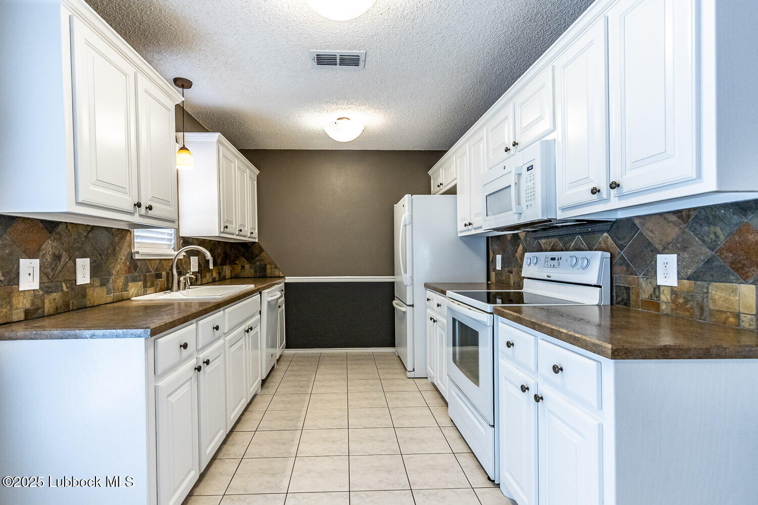 6120 7th Drive Lubbock, TX 79416 - Photo 11 of 33 a kitchen with stainless steel appliances granite countertop a sink and cabinets