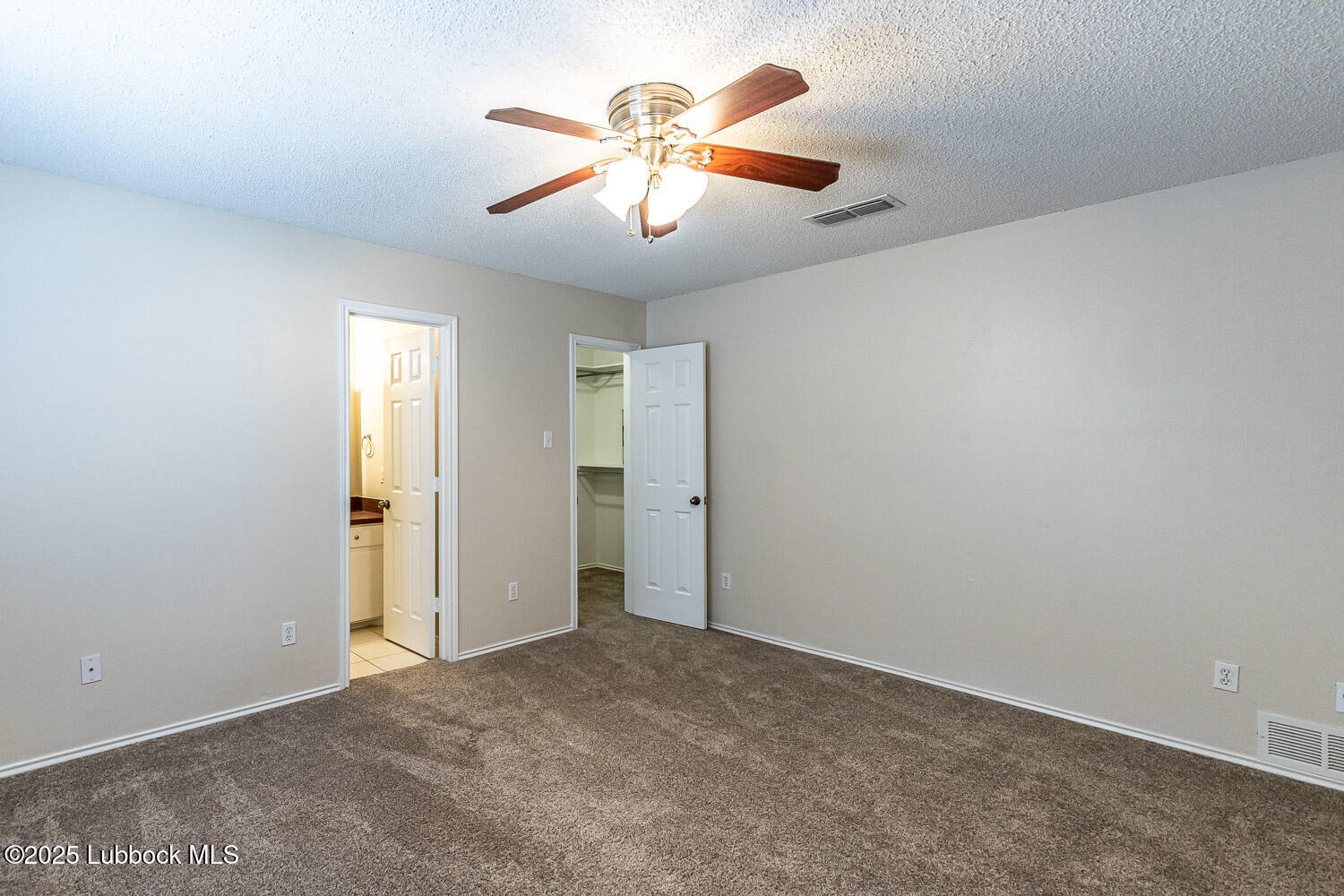 6120 7th Drive Lubbock, TX 79416 - Photo 17 of 33 an empty room with closet and a ceiling fan