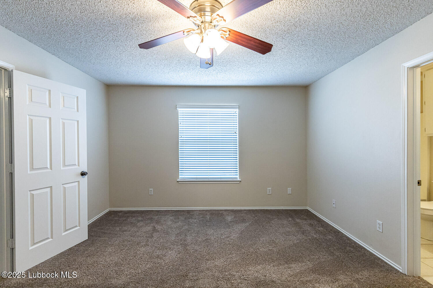 6120 7th Drive Lubbock, TX 79416 - Photo 19 of 33 an empty room with a window and a fan