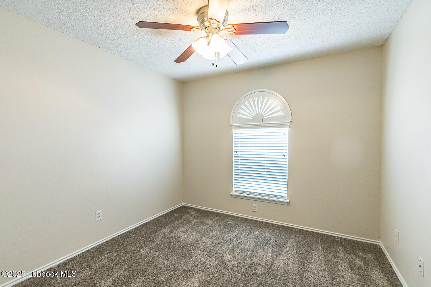 6120 7th Drive Lubbock, TX 79416 - Photo 22 of 33 an empty room with windows and fan