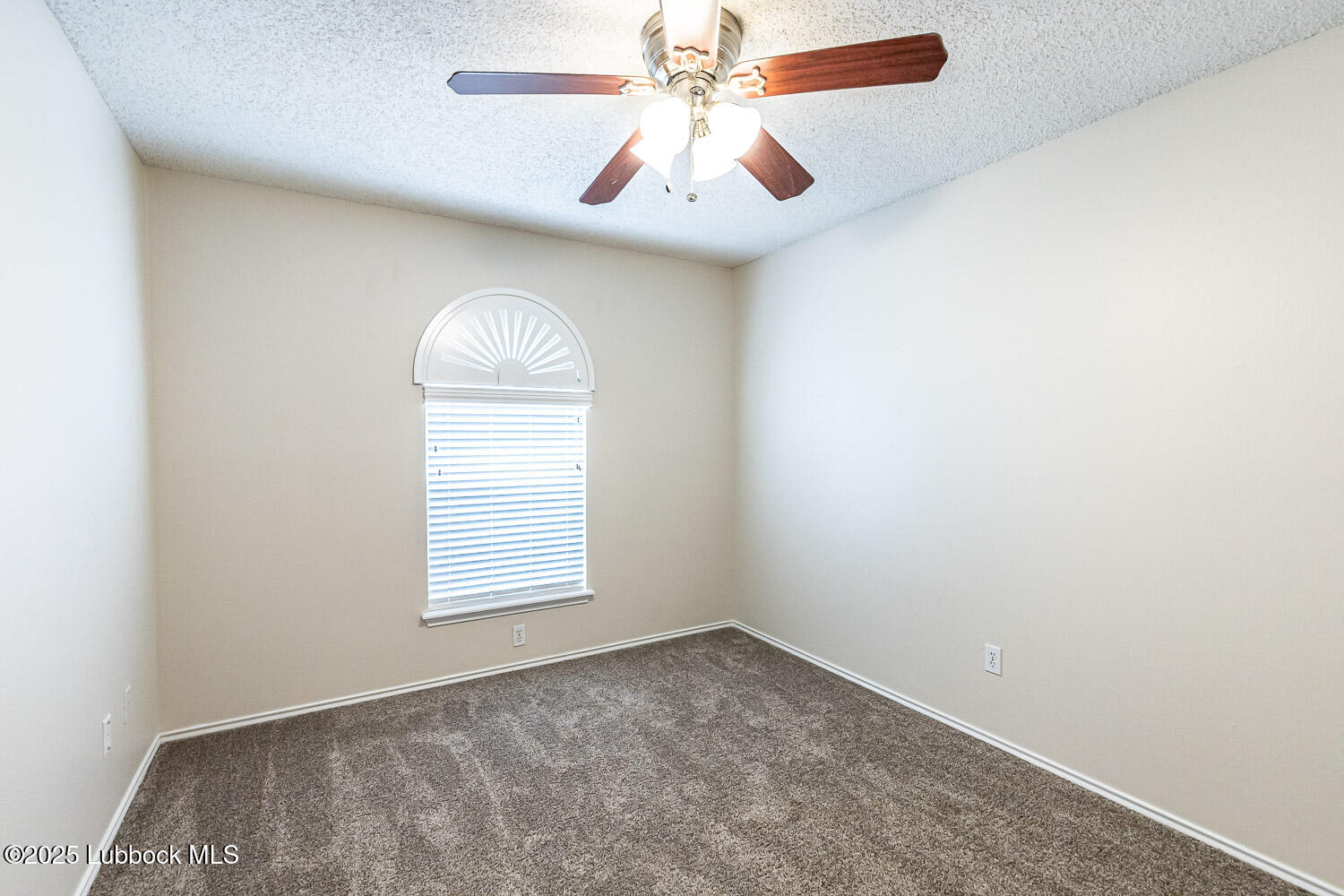 6120 7th Drive Lubbock, TX 79416 - Photo 25 of 33 an empty room with a window and a fan