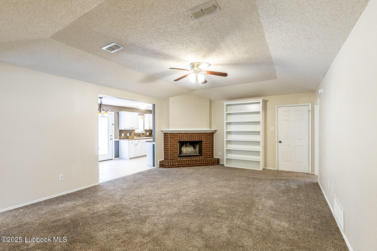 6120 7th Drive Lubbock, TX 79416 - Photo 4 of 33 a view of a room with a fireplace and a window