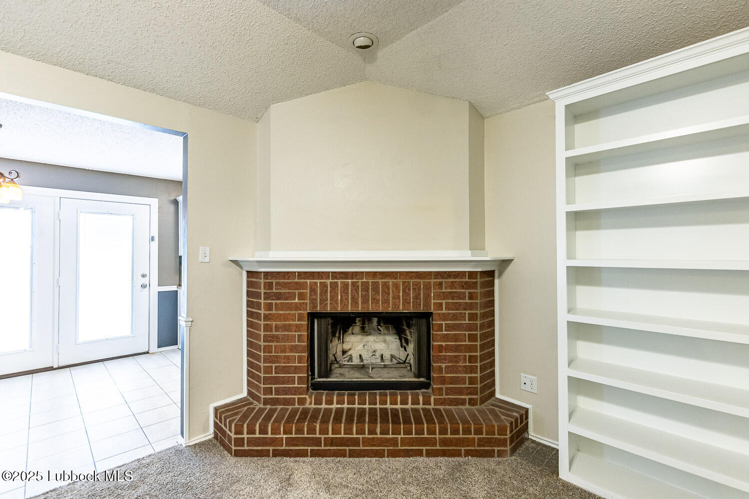 6120 7th Drive Lubbock, TX 79416 - Photo 5 of 33 a living room with a fireplace and a rug