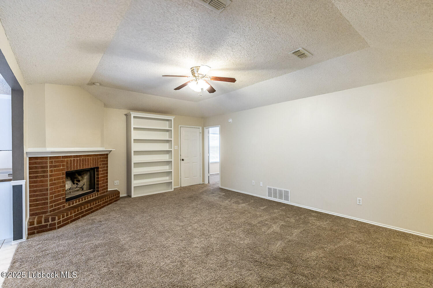 6120 7th Drive Lubbock, TX 79416 - Photo 6 of 33 a view of empty room with a fireplace