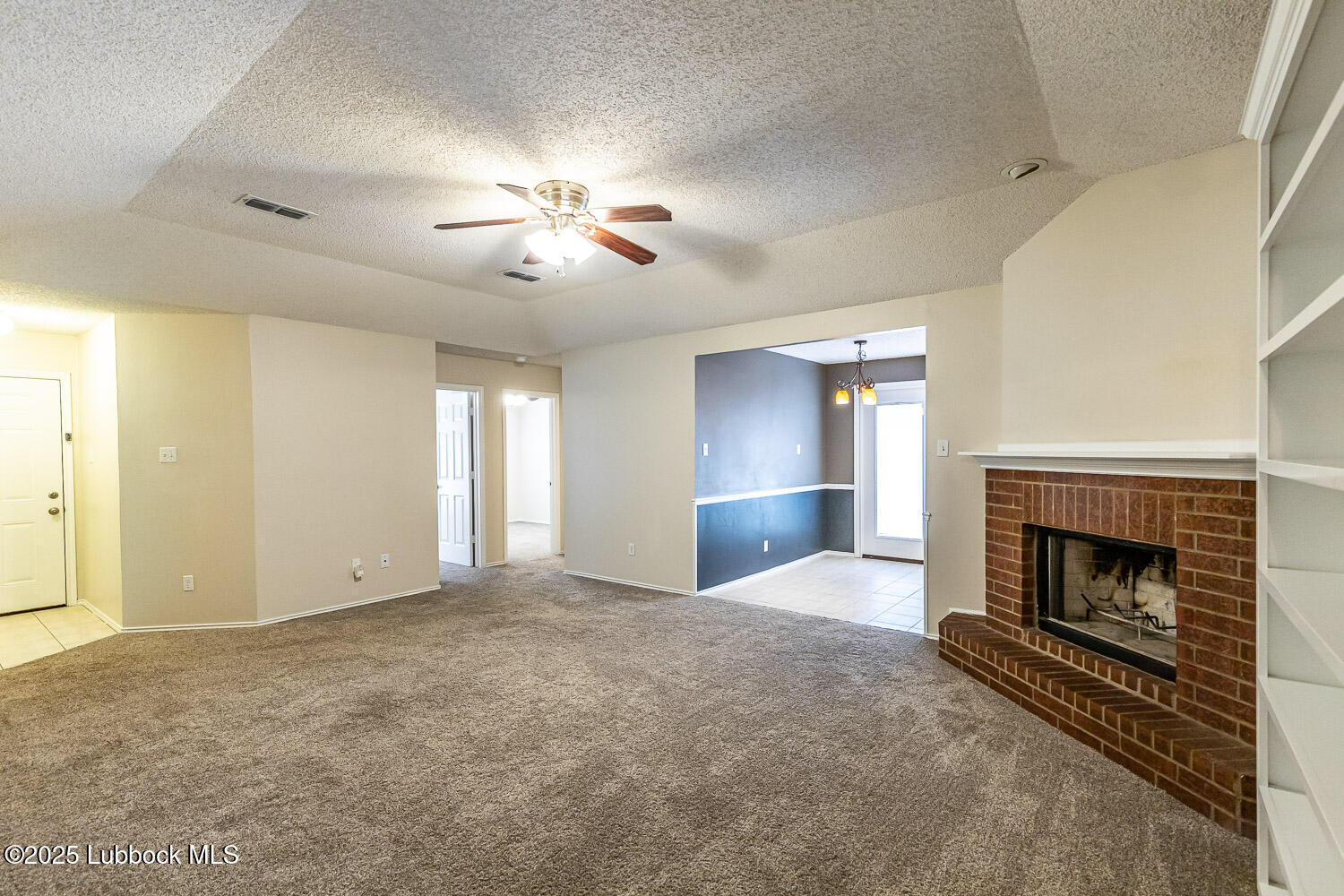6120 7th Drive Lubbock, TX 79416 - Photo 8 of 33 an empty room with windows and fireplace