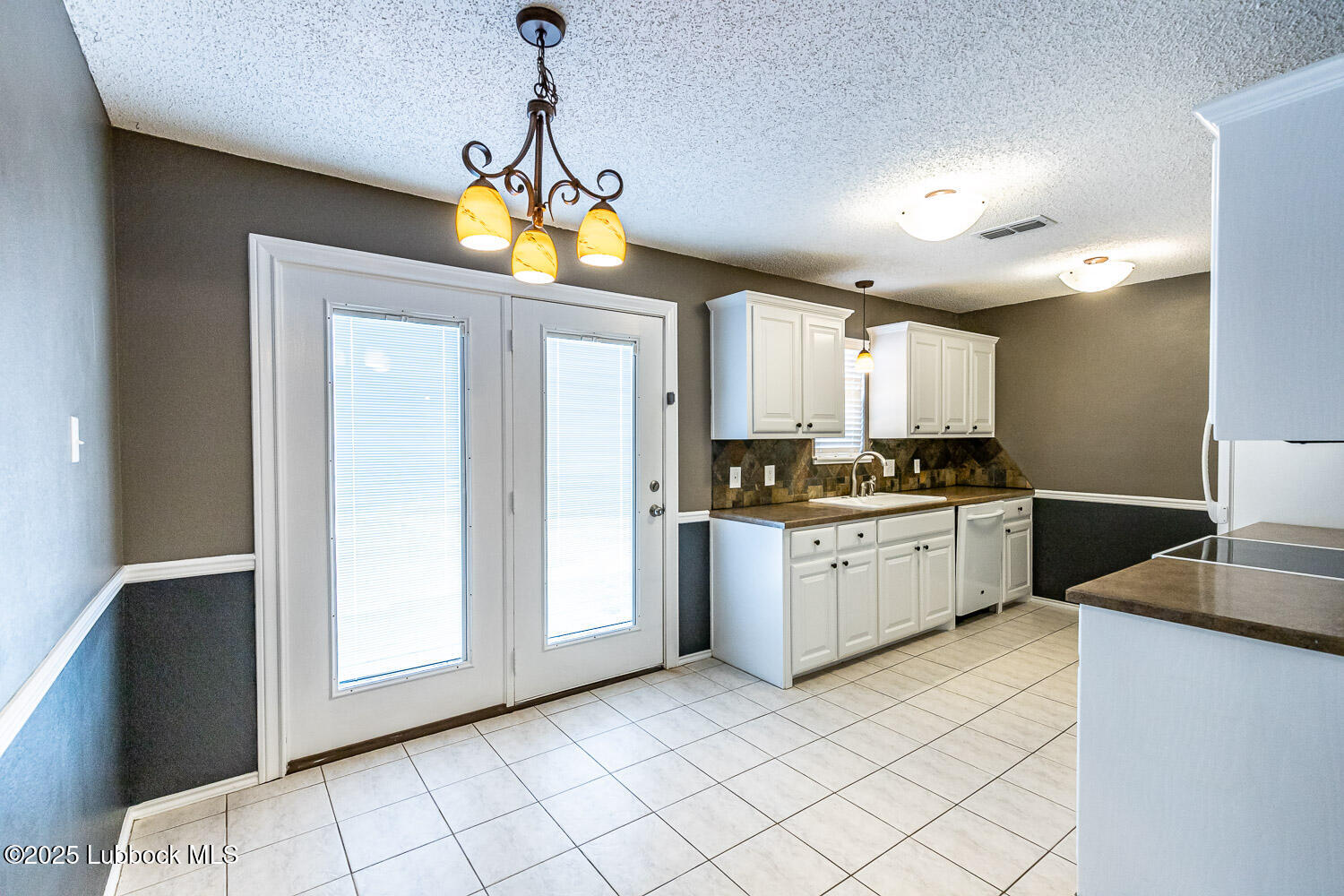 6120 7th Drive Lubbock, TX 79416 - Photo 9 of 33 a kitchen with cabinets and window