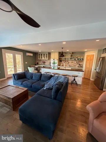 a living room with lots of furniture and a large window