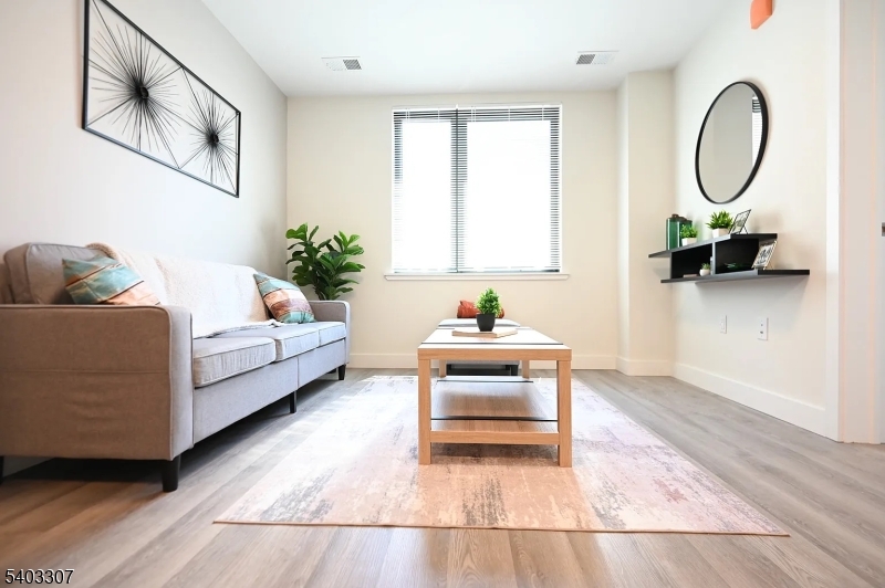 49 South Day Street, Unit 316 Orange, NJ 07050 - Photo 1 of 26 a living room with furniture and a window