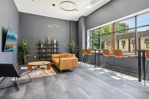 a living room with furniture and a floor to ceiling window