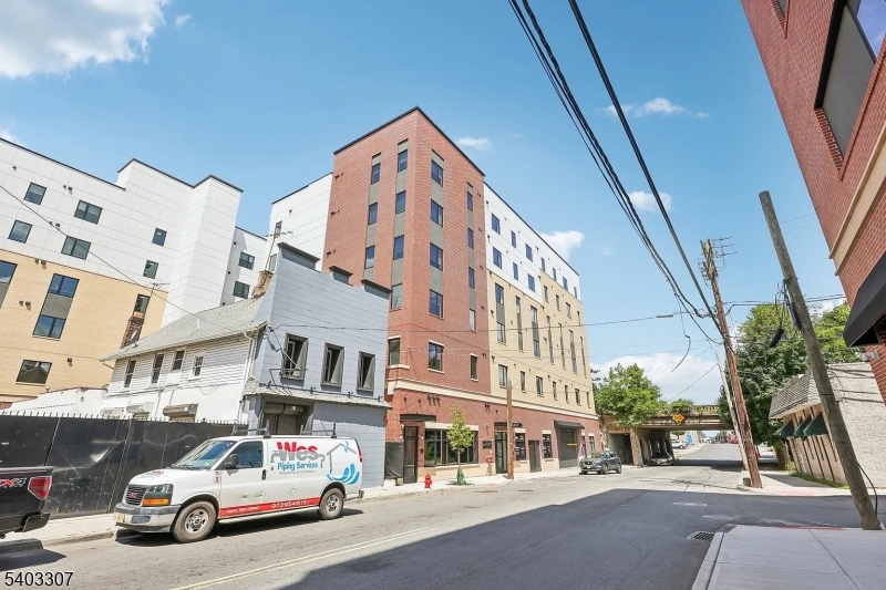 49 South Day Street, Unit 316 Orange, NJ 07050 - Photo 20 of 26 a car parked in front of a building