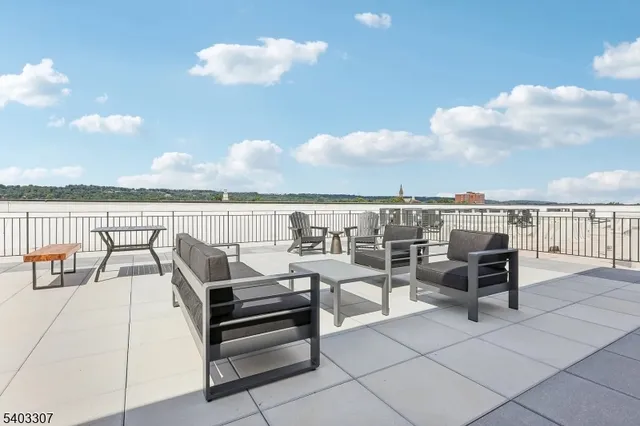 a view of a terrace with lawn chairs