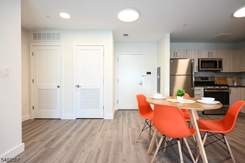 49 South Day Street, Unit 316 Orange, NJ 07050 - Photo 3 of 26 a dining room with furniture and wooden floor