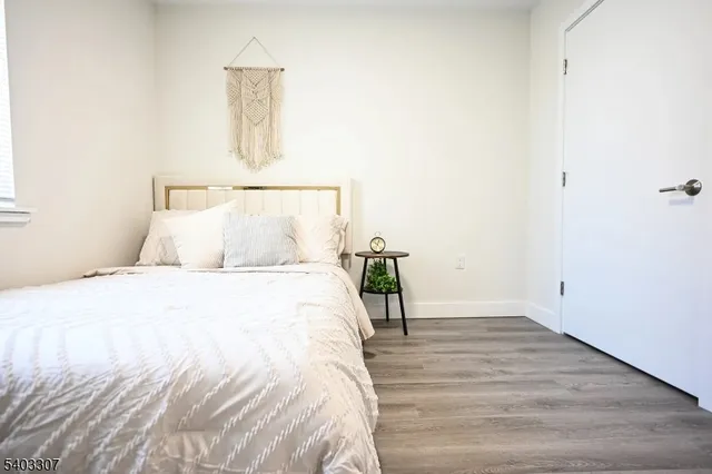 a bed room with a bed and a night stand