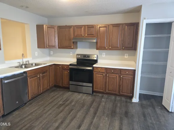 a kitchen with stainless steel appliances granite countertop a refrigerator sink and cabinets