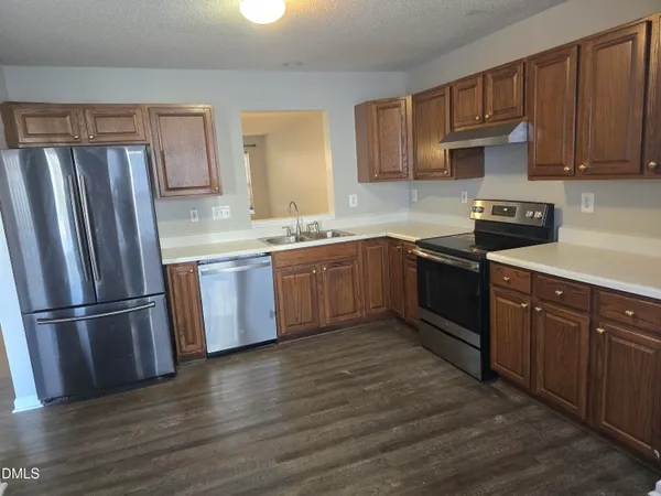 a kitchen with a sink a stove and cabinets