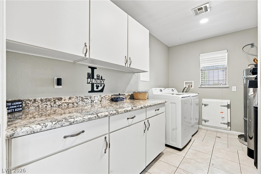 7744 Rancho Destino Road Las Vegas, NV 89123 - Photo 28 of 48 Functional workspace highlights this utility area featuring durable stone countertops and classic tile flooring.