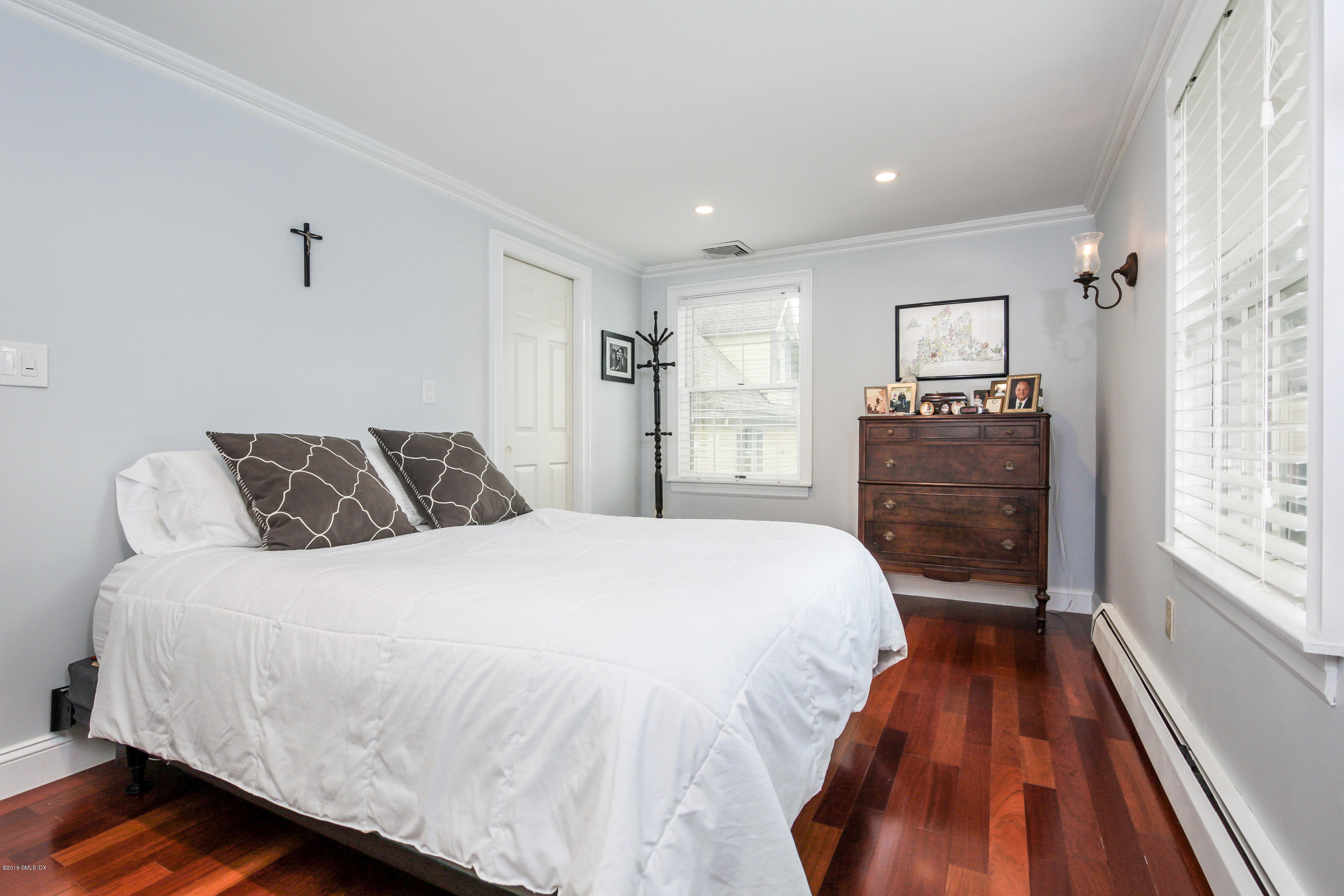 52 Ute Place, Unit A Greenwich, CT 06830 - Photo 16 of 32 a bedroom with a bed and wooden floor