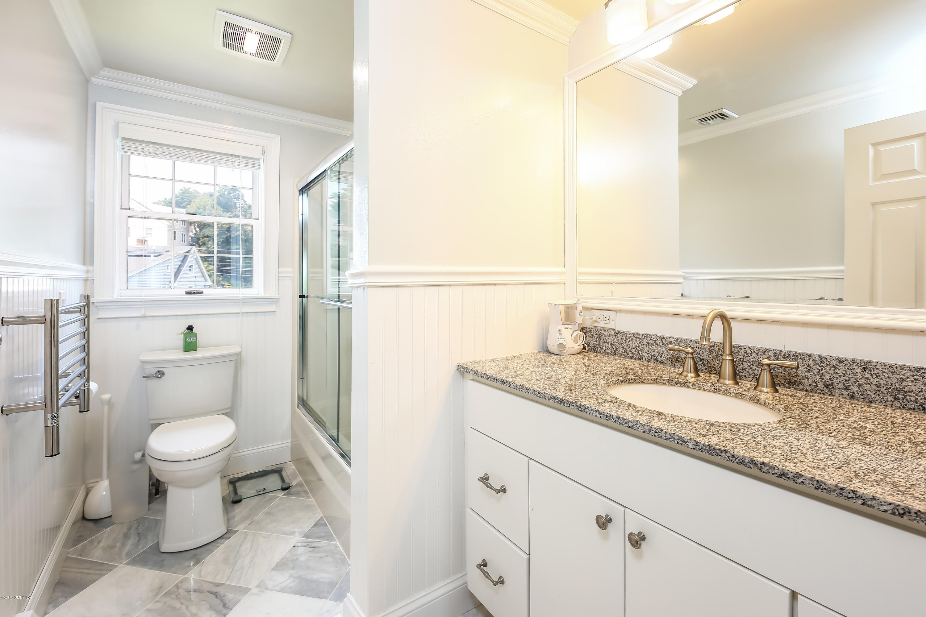 52 Ute Place, Unit A Greenwich, CT 06830 - Photo 17 of 32 a bathroom with a granite countertop toilet a sink and a mirror