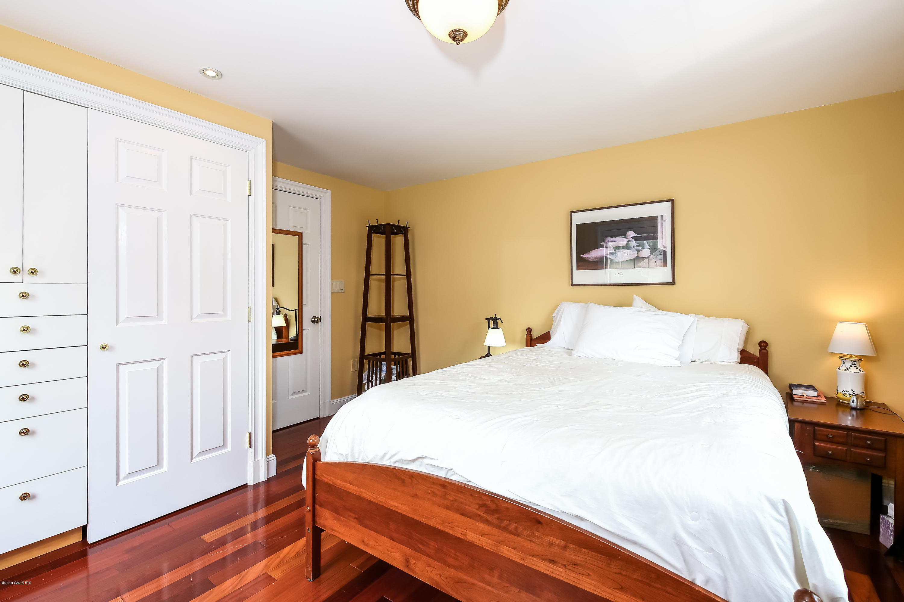 52 Ute Place, Unit A Greenwich, CT 06830 - Photo 19 of 32 a bedroom with a bed and wooden floor