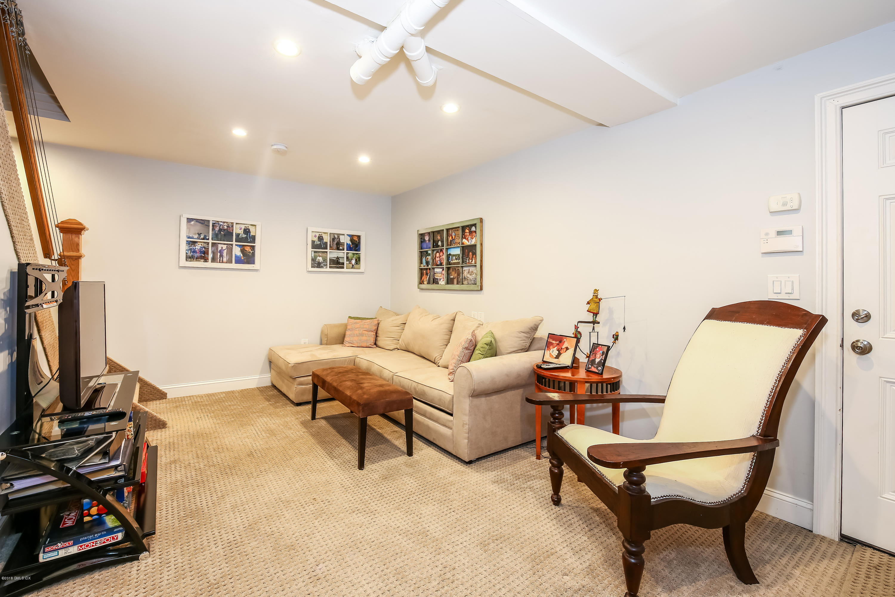 52 Ute Place, Unit A Greenwich, CT 06830 - Photo 23 of 32 a living room with furniture and a flat screen tv