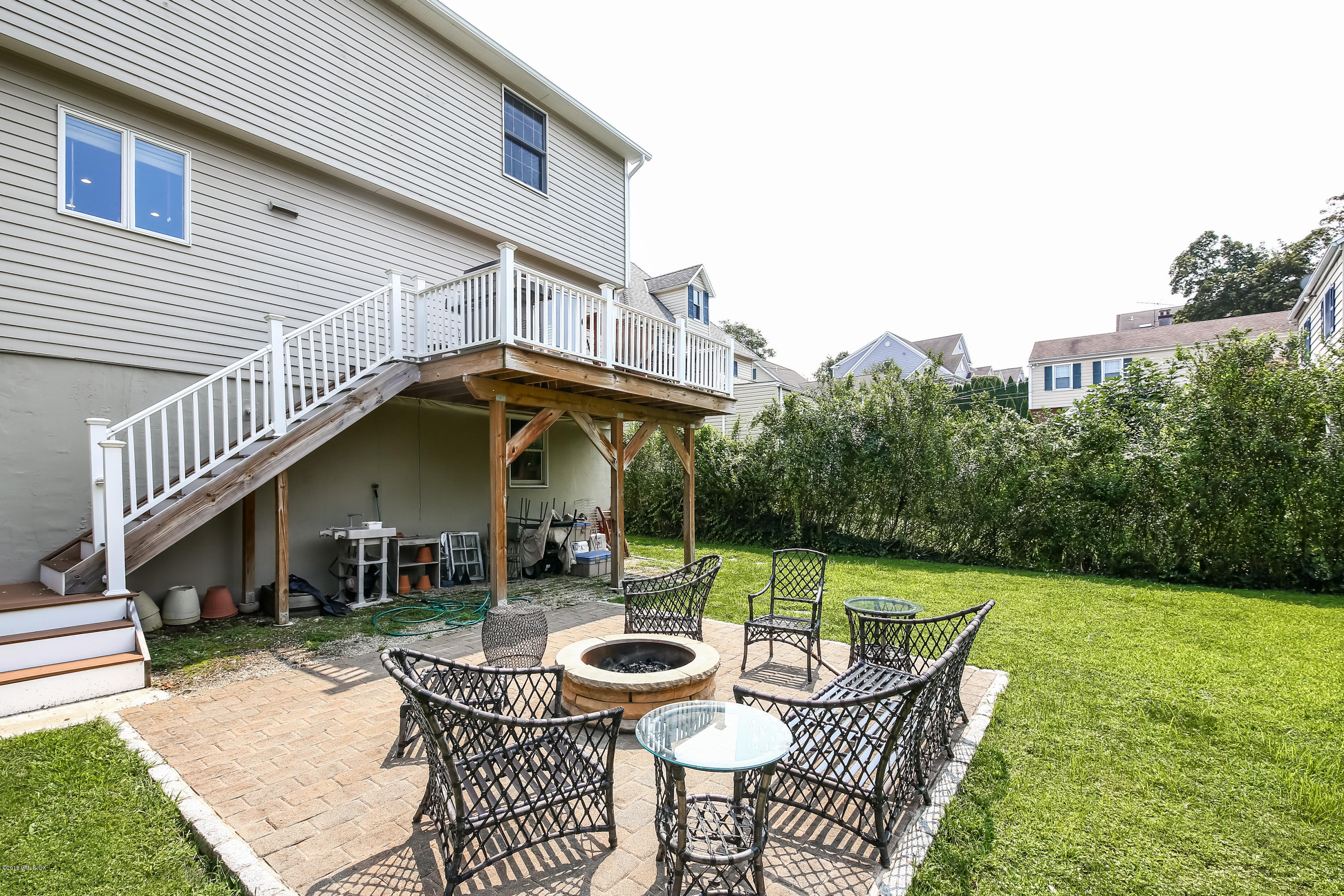 52 Ute Place, Unit A Greenwich, CT 06830 - Photo 30 of 32 a view of a chair and table in backyard of the house